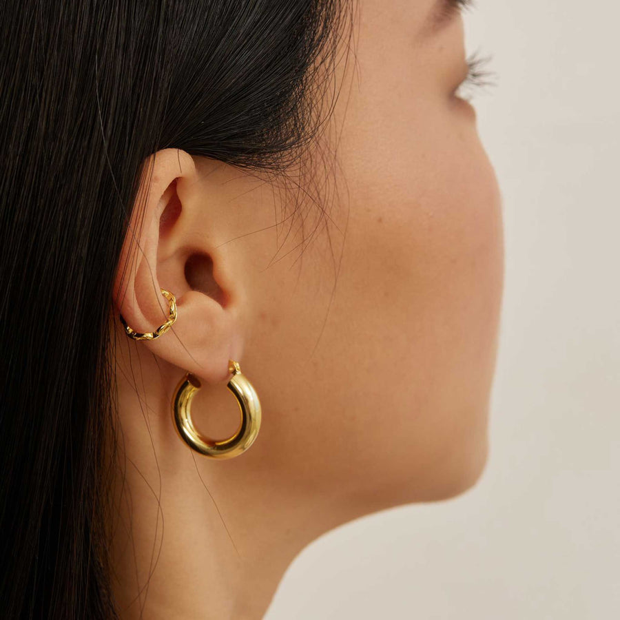 women wearing cuff earrings gold